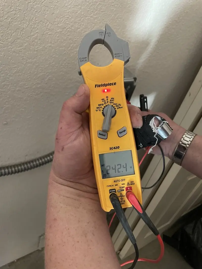 Voltage testing with clamp meter during Outlet Installation in Taylor Lake Village
